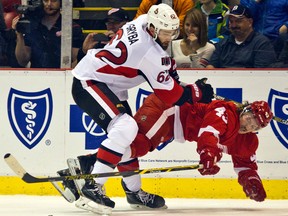 Ottawa defenceman Eric Gryba, left, checks Detroit's Darren Helm Monday at Joe Louis Arena. (AP Photo/Tony Ding)