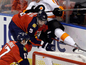 Belle River's Aaron Ekblad, left, checks Philadelphia's Brayden Schenn Saturday in Sunrise, Fla. (AP Photo/Alan Diaz)