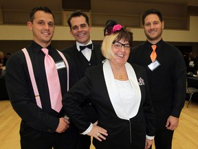 Top diva, Gale Simko-Hatfield poses with Ben Parent, left, Dino Villalta and Claudio Pullo during A Girls' Night Out in Handbag Heaven hosted by Do Good Divas Wednesday October 29, 2014. Ariana's mother, Caitlyn Miller watches the action during the sold out event, held at Giovanni Caboto Club of Windsor.  (NICK BRANCACCIO/The Windsor Star)