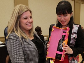 Melissa Sampson, left, and Danit Li, check out a bottle purse during A Girls' Night Out in Handbag Heaven by Do Good Divas Wednesday October 29, 2014.  The sold out event was held at Giovanni Caboto Club of Windsor.  (NICK BRANCACCIO/The Windsor Star)