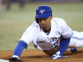 Anthony Gose dives back to first base on a pick-off attempt against the St. Louis Cardinals on June 6, 2014 at Rogers Centre in Toronto, Ontario, Canada. The Blue Jays traded Gose to the Detroit Tigers for prospect second baseman Devon Travis. (Photo by Tom Szczerbowski/Getty Images)