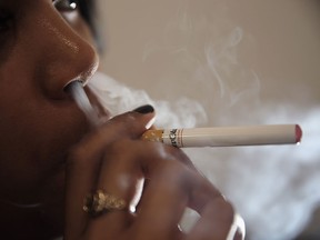 In this photo illustration, a woman smokes an E-Cigarette at the V-Revolution E-Cigarette shop in Covent Garden on August 27, 2014 in London, England. (Photo by Dan Kitwood/Getty Images)