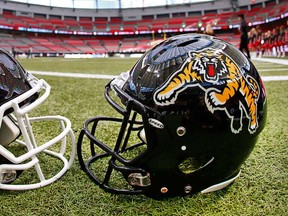 The Calgary Stampeders and the Hamilton Tiger-Cats helmets sit on the field inside B.C. Place, site the 102nd Grey Cup Championship Game on November 30, 2014 in Vancouverr. (Jeff Vinnick/Getty Images)