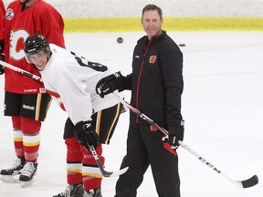 Calgary Flames goalie coach Clint Malarchuk, right, takes a break during Flames practice in 2011.  (Leah Hennel/Calgary Herald)