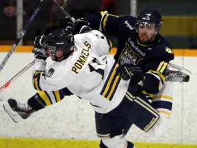 The University of Windsor's Spencer Pommells, left, collides with Lakehead's Cody Alcock at South Windsor Arena. (TYLER BROWNBRIDGE/The Windsor Star)