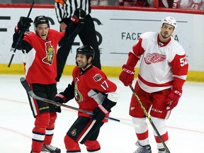 Ottawa's Mark Stone, left, celebrates with ex-Wing David Legwand as Detroit's Jonathan Ericsson looks on during second-period action in Ottawa Tuesday. (THE CANADIAN PRESS/Fred Chartrand)