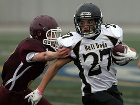 General Amherst's Douglas Leake, right, eludes a tackle by Leamington's Ben Fehr at Alumni Field Thursday. (TYLER BROWNBRIDGE/The Windsor Star)