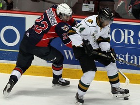 Windsor's Sam Povorozniouk, left, checks London's Gemel Smith at the WFCU Centre. (TYLER BROWNBRIDGE/The Windsor Star)