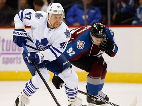 Toronto's Leo Komarov, left, is checked by Colorado's Gabriel at the Pepsi Center in Denver.(Photo by Doug Pensinger/Getty Images)