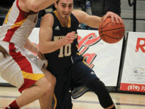 Lancers guard Mike Rocca, right, drives to the basket against the Guelph Gryphons at the St. Denis Centre Saturday. (DAX MELMER/The Windsor Star)