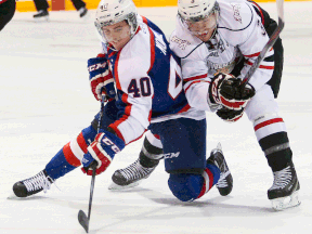 Windsor's Ryan Moore, left, is checked by Owen Sound's Connor Walters during the Attack's 3-0 win Saturday. (Owen Sound Sun TImes)