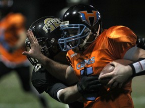 Hamilton quarterback, Kyle Johnston, is pushed out of bounds by AKO's Jake Nicoletti during the OFC Championship game between the AKO Fratmen and the Hamilton Hurricanes at Windsor Stadium, Saturday, Nov. 1, 2014. AKO captured the championship by a score of 18-10. (DAX MELMER/The Windsor Star)