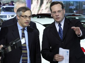 Tony Clement, left, former Canadian federal Minister of Industry gets a tour of the North American International Auto Show at the Cobo Center on January 11, 2011 in Detroit from auto analyst Michael Robinet. (DAN JANISSE/The Windsor Star)