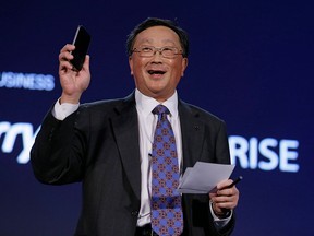 BlackBerry CEO John Chen holds up a Classic phone, which will be released Dec. 17, during the BlackBerry Enterprise Portfolio Launch event Thursday, Nov. 13, 2014, in San Francisco. (AP Photo/Eric Risberg)