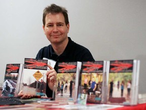 Local inspirational author and speaker Kit McCann is pictured with his book Moving 4Ward Beyond Obstacles at the 3rd annual Windsor Essex Book Expo, Sunday, Nov. 23, 2014, at the St Clair College Centre for the Arts. There were 64 authors featured at this year's expo and between 250-300 visitors. (RICK DAWES/The Windsor Star)