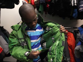 Glenand Graham, 7, tries on a winter jacket at the 29th annual Coats for Kids at the Unemployed Help Centre, Saturday, Nov. 8, 2014..  (DAX MELMER/The Windsor Star)