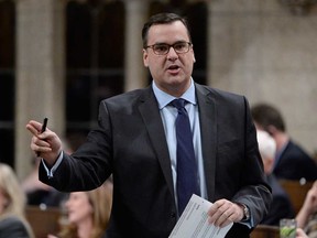 Industry Minister James Moore responds to a question in the House of Commons in Ottawa, Tuesday, Nov. 25, 2014. THE CANADIAN PRESS/Adrian Wyld