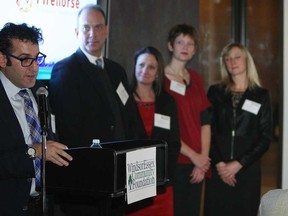 Jay Strosberg, left, presents Firehorse Leadership Organization a grant during a Windsor Essex Community Foundation annual general meeting in Windsor on Monday, November 24, 2014.                    (TYLER BROWNBRIDGE/The Windsor Star)