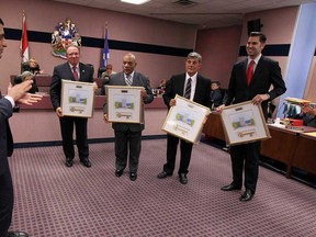 Mayor Eddie Francis presents out going councillors Fulvio Valentinis, left, Ron Jones, Al Halberstadt and Al Maghnieh with their own keys to the city during the final council meeting for the current members of council at city hall in Windsor on Monday, November 17, 2014.  (TYLER BROWNBRIDGE/The Windsor Star)