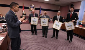 Mayor Eddie Francis presents out going councillors Fulvio Valentinis, left, Ron Jones, Al Halberstadt and Al Maghnieh with their own keys to the city during the final council meeting for the current members of council at city hall in Windsor on Monday, November 17, 2014.  (TYLER BROWNBRIDGE/The Windsor Star)