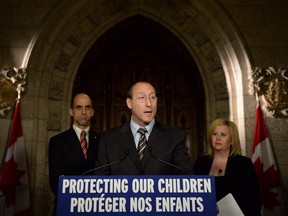 In this file photo, Peter MacKay, Minister of Justice and Attorney General of Canada speaks as Steven Blaney, Minister of Public Safety and Emergency Preparedness, back right, Lianna McDonald, Executive Director of the Canadian Centre for Child Protection, join him in making an announcement on Parliament Hill in Ottawa on Wednesday, Nov. 20, 2013., as part of Bullying Awareness Week. THE CANADIAN PRESS/Sean Kilpatrick