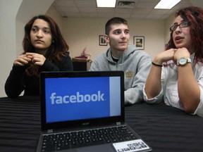 Grade twelve students from Catholic Central  Sandy Hanny, left, Kyle Cacilhas, and Melissa Fares, all 17, talk about online bullying, Monday, Nov. 17, 2014. On Wednesday students at the school will be invited to take part in Delete Day in which they delete inappropriate social media comments.  The event is part of Bullying Awareness Week.  (DAX MELMER/The Windsor Star)