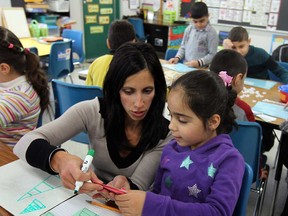 Teacher Lisa Mosca works with ESL students as they participate in a special pilot program at Immaculate Conception School in Windsor on Thursday, November 27, 2014. The program offers ESL students a chance to get intensive 12 week education for 3 hours a day.                   (TYLER BROWNBRIDGE/The Windsor Star)