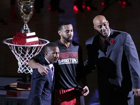 Windsor Express team president Dartis Willis, left, Express player R. J. Wells and head coach Bill Jones pose for photographs after Wells received his championship ring during pre-game ceremonies at WFCU Centre November 7, 2014.  (NICK BRANCACCIO/The Windsor Star)