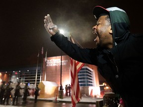 "This must stop," yells a protester to Missouri National Guardsmen who were posted outside the Ferguson Police Department on Wednesday, Nov 26, 2014, during protests over the grand jury decision in the Michael Brown case. (AP Photo/St. Louis Post-Dispatch, Laurie Skrivan)