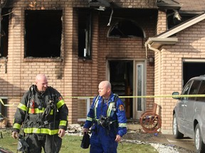 Windsor Fire and Rescue work at the scene of a house fire at 4183 Spago Cres., Saturday, Nov. 29, 2014.  The fire was determined to be set intentionally.  No injuries were reported.  Damage was pegged at $275,000.    (DAX MELMER/The Windsor Star)