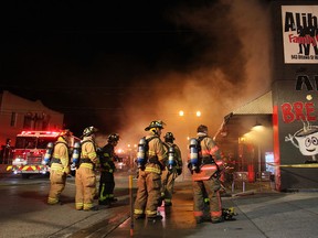 Windsor firefighters tend to an early morning structure fire at a commercial and residential building at 943 Ottawa St., Saturday, Nov. 8, 2014.  One firefighter was taken to hospital with non life-threatening injuries.  The residents on the upper floor exited safely.  (DAX MELMER/The Windsor Star)