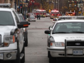 Windsor police cruisers sit parked outside 943 Ottawa St. where there was a fire early Saturday morning while Windsor Fire and Rescue dealt with a second fire at 812 Ottawa St. Sunday afternoon, Nov. 9, 2014.  (DAX MELMER/The Windsor Star)