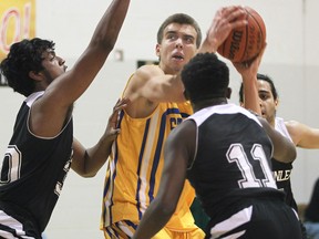 Anne's Anthony Zrvnar gets triple-teamed by Thornlea's Niroshon Surendran (L), Kimberl Saint Felix and Brandon Persad during the Freeds Tip Off Basketball Tournament on Friday, Nov. 28, 2014, at the St. Clair College.  (DAN JANISSE/The Windsor Star)