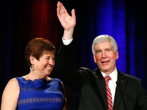 Gov. Rick Snyder, with his wife Sue, waves to supporters  at a election night party in Detroit Tuesday, Nov. 4, 2014. Snyder won a second term Tuesday, defeating Democrat Mark Schauer after a race in which the Republican touted an economic and fiscal turnaround and promised to keep Michigan on the right path. (AP/Paul Sancya)