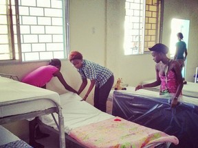 Girls make beds at Frank Chauvin's new orphanage in Haiti, replacing the one damaged in the 2010 earthquake. (Photo by Don Lajoie)