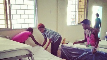 Girls make beds at Frank Chauvin's new orphanage in Haiti, replacing the one damaged in the 2010 earthquake. (Photo by Don Lajoie)