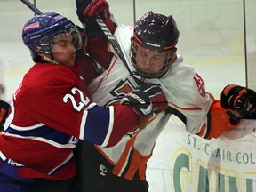 Brendan Crundwell, left, of the Lakeshore Canadiens checks Essex's William Stadder during Great Lakes Junior C Hockey League action at Lakeshore Arena Friday November 14, 2014. (NICK BRANCACCIO/The Windsor Star)