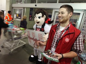 Windsor Star reporter, Rick Dawes, jingles his bells as he volunteers with the Salvation Army at Windsor's Costco, Saturday, Nov. 29, 2014.  (DAX MELMER/The Windsor Star)