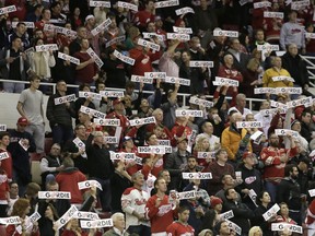 Fans wave "Get Well Gordie" signs for Detroit Red Wings legend Gordie Howe during the first period of the game between the Red Wings and Los Angeles Kings Friday, Oct. 31, 2014, in Detroit. Howe suffered a stroke on Sunday. (AP Photo/Duane Burleson)