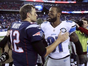 New England Patriots quarterback Tom Brady (12) speaks to Detroit Lions wide receiver Calvin Johnson (81) Sunday, Nov. 23, 2014, in Foxborough, Mass. The Patriots won 34-9. (AP Photo/Stephan Savoia)