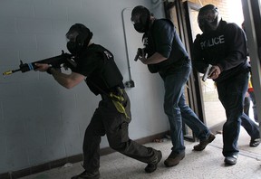 The Windsor Police Service held a training exercise on Thursday, Nov. 6, 2014, to simulate a live shooter situation at a school. Officers move towards the conflict during the exercise. (DAN JANISSE/The Windsor Star)