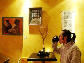 In this file photo, David Xiong, of Windsor, enjoys a warm drink at Milk Sunday evening. The coffee bar caters to an alternative crowd and displays various artists work. (Windsor Star-Brent Foster)