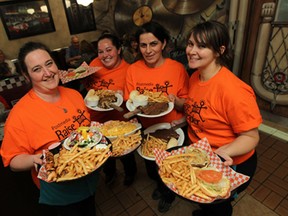 Waitresses Sonja Sweet, Renee Ouellette, Mentore Bojaj and Alysa Acchione (left to right) carry food out from the kitchen during Raise-A-Reader day at the Michigan Diner at Tecumseh and Lauzon roads in Windsor on November 10, 2014. The restaurant donated all profits from the day to the campaign.                     (TYLER BROWNBRIDGE/The Windsor Star)