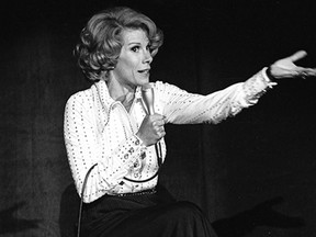 In this Aug. 13, 1975 photo released by the Las Vegas News Bureau, comedian Joan Rivers performs at the MGM in Las Vegas, Nev. Rivers, the raucous, acid-tongued comedian who crashed the male-dominated realm of late-night talk shows and turned Hollywood red carpets into danger zones for badly dressed celebrities,  died Sept. 4, 2014. She was 81. Rivers was hospitalized Aug. 28, after going into cardiac arrest at a doctor's office. (AP Photo/Las Vegas News Bureau)