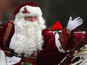 Santa Claus waves to spectators during the Downtown Windsor BIA's Holiday Parade in downtown Windsor, Saturday, Nov. 29, 2014.  (DAX MELMER/The Windsor Star)