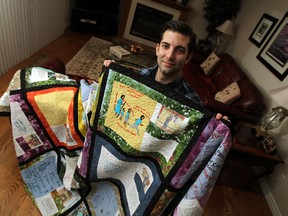 Dane Macri displays a quilt in his home in Windsor on Thursday, November 13, 2014. Macri was in northern Uganda in 2012 and had people with disabilities there tell their story on quilt blocks. It was pieced together and quilted in Windsor to give people with disabilities in Uganda a voice and to advocate for people with disabilities who live with poverty and discrimination. (TYLER BROWNBRIDGE/The Windsor Star)
