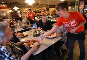 The Michigan Diner in Tecumseh, opened its doors to raise money for local literacy programs Monday, Nov. 19, 2012, donating 100 per cent of their sales to The Windsor Star's Raise-A-Reader campaign. Server Angela Finley serves up some of the food during the fundraiser.  (DAN JANISSE/The Windsor Star)