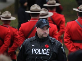 A Windsor police officer patrols the Remembrance Day service in downtown Windsor, Sunday, Nov. 9, 2014.  A large police presence was patrolling the Remembrance Day service Sunday.(DAX MELMER/The Windsor Star)
