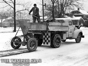 Snow covered and slippery roads caused by winter's first icy blasts in this district on Jan. 6, 1950 brought out city and S.W. and A. Railway sanding trucks. Tons of sand and salt mixture were scattered over the glazed street surfaces today. The bus company concentrated on its routes while the public works department sanded main intersections and miles of busy thoroughfares. This picture shows one of the city trucks engaged in sanding Ouellette avenue near Tecumseh road. Mr. John Sabolcik, city employee, is shovelling sand through the distributor. (FILES/The Windsor Star)