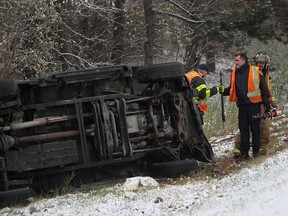 In this file photo, Windsor firefighters work at the scene of a single vehicle rollover on the east-bound E.C. Row Expressway off-ramp at Dougall Avenue, Monday, Nov. 17, 2014.  No injuries were reported.  (DAX MELMER/The Windsor Star)